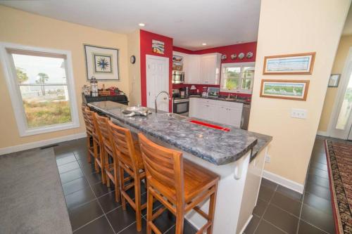 a kitchen with a counter and some chairs in it at BEACH FRONT!!! Steps from the Beach - Fantastic Views in Harbor Island