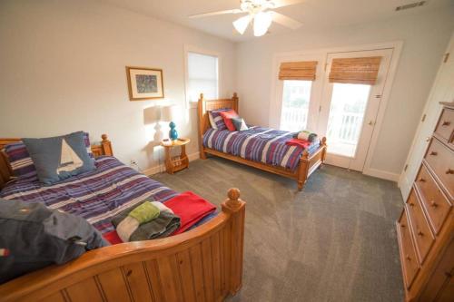 a bedroom with two beds and a dresser at BEACH FRONT!!! Steps from the Beach - Fantastic Views in Harbor Island