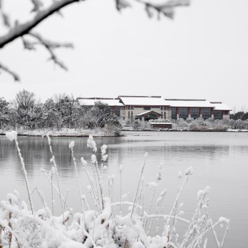 a body of water with a building in the background at Holiday Inn Kunshan Huaqiao by IHG in Kunshan