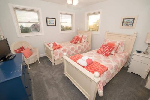 a bedroom with two beds and a tv and windows at BEACH FRONT!!! Steps from the Beach - Fantastic Views in Harbor Island