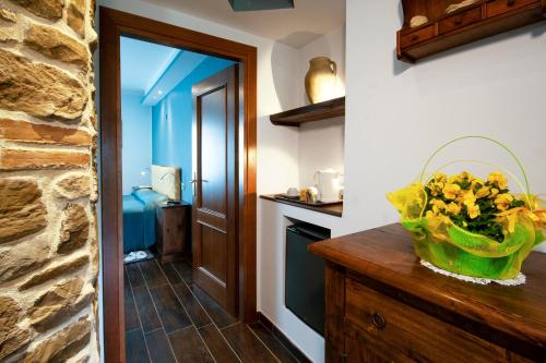 a kitchen with a vase of flowers on a dresser at Santa Maria Degli Ancillotti in Petrignano