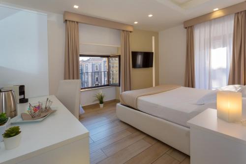 Ένα ή περισσότερα κρεβάτια σε δωμάτιο στο Le Suites Del Duomo