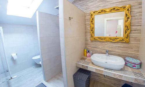 a bathroom with a sink and a mirror at Villa VAND Paradiso in Međugorje