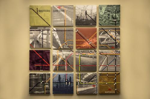 a collage of photographs hanging on a wall at Holiday Inn London Watford Junction by IHG in Watford