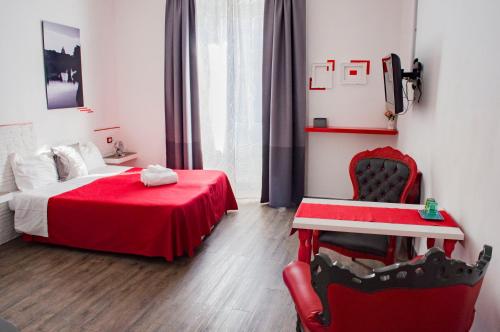 ローマにあるルレ コーラ ディ リエンツォのベッドルーム1室(赤いベッド1台、赤い椅子付)