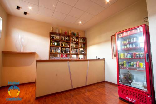a red refrigerator in a room with a counter at HOTEL CASTELO in San Juan del Río