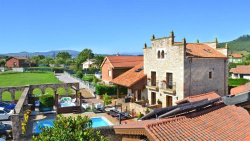 an aerial view of a village with a building and a pool at Posada la Leyenda in Santillana del Mar