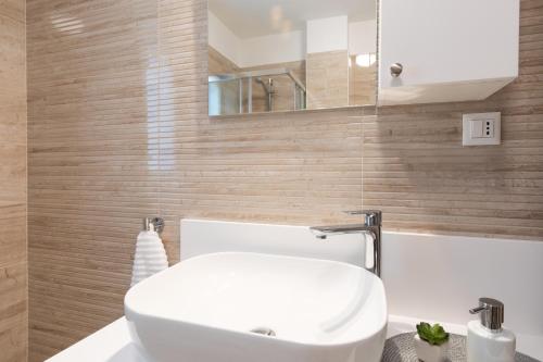 a bathroom with a white sink and a mirror at Villa Diamond - Muraj Krk in Kornić
