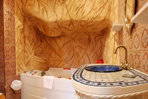 a bathroom with a toilet with a wooden wall at Posada la Leyenda in Santillana del Mar