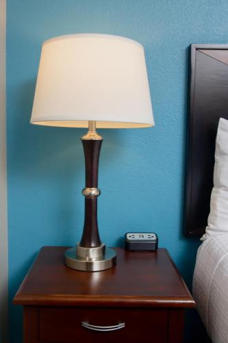 a lamp on a table next to a bed at Belltown Inn in Seattle