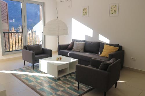a living room with a couch and two chairs at Lavender Bay Apartments D3 or D5 I by Andreas Crivellaro in Donji Morinj