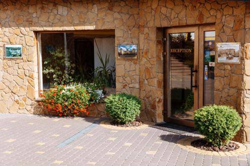 a entrance to a building with flowers in front of it at Argo in Lviv