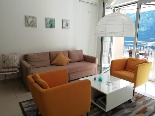 a living room with a couch and chairs and a table at Lavender Bay Apartments D3 or D5 I by Andreas Crivellaro in Donji Morinj