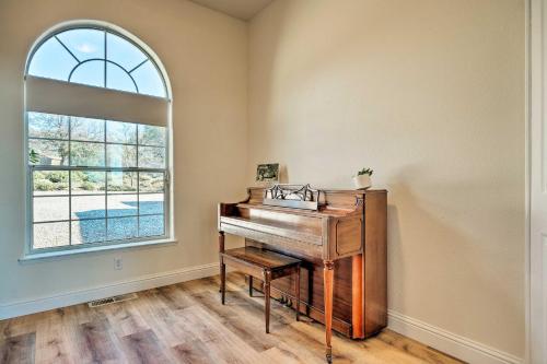 a piano in a room with a window at Hot Tub and Mtn Views Peaceful Columbia Retreat! in Columbia