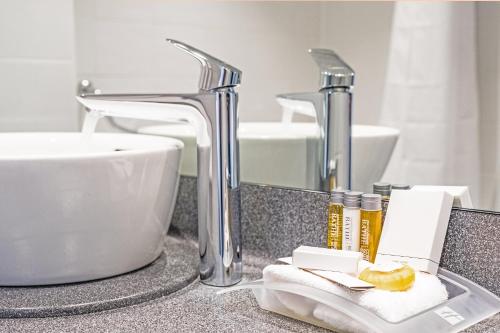 a bathroom counter top with a sink and a sink at Holiday Inn Farnborough, an IHG Hotel in Farnborough