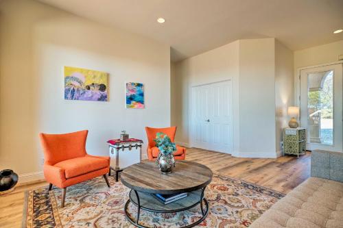 a living room with orange chairs and a table at Hot Tub and Mtn Views Peaceful Columbia Retreat! in Columbia