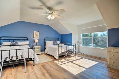 a blue bedroom with two beds and a ceiling fan at Peaceful Retreat with Hot Tub and Sierra Mtn Views! in Columbia