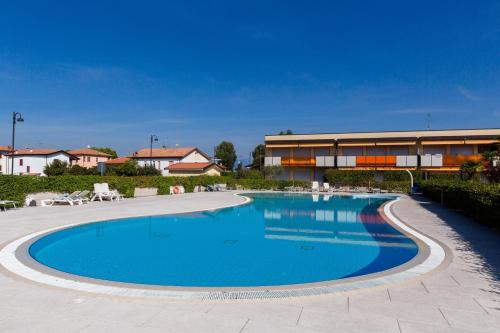 a large swimming pool in front of a building at Appartamento Atlantis in Sirmione