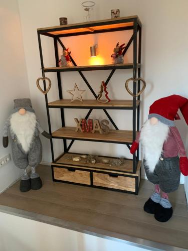 two stuffed animals standing next to a shelf with a mirror at Stadtvilla Intzeplatz - Apartment Föhr in Remscheid