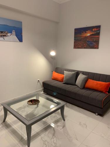 a living room with a couch and a glass table at V17 Syntagma Studio in Athens