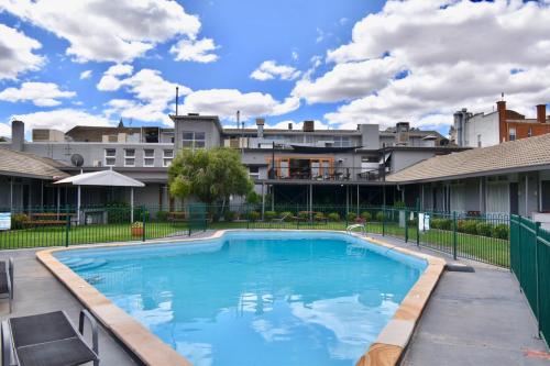 a swimming pool in the middle of a building at Townhouse Motel Cowra in Cowra
