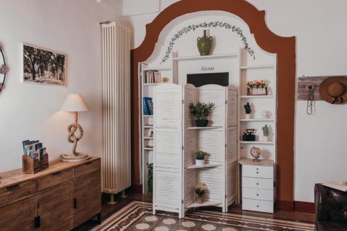 a room with a large white book shelf at Dimora Antica Perla in Fasano