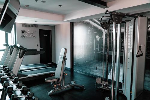 a gym with a treadmill and a glass wall at The Wild Oscar in Mexico City