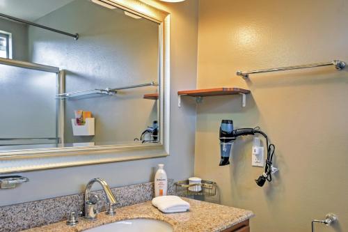 a bathroom with a sink and a mirror at Long Beach Condo with Balcony about 2 Mi to Downtown! in Long Beach