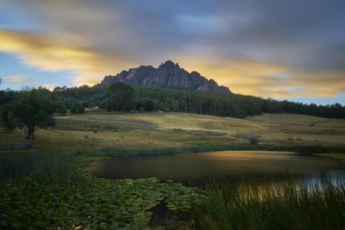 a mountain in the distance with a pond and trees at Silver Ridge Retreat in Sheffield