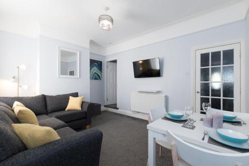 a living room with a couch and a table at Northwood Park East in Stoke on Trent