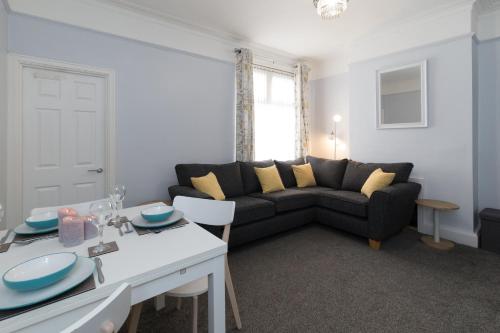 a living room with a couch and a table at Northwood Park East in Stoke on Trent