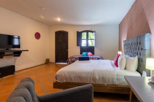 Postel nebo postele na pokoji v ubytování Hotel Hacienda San Cristóbal
