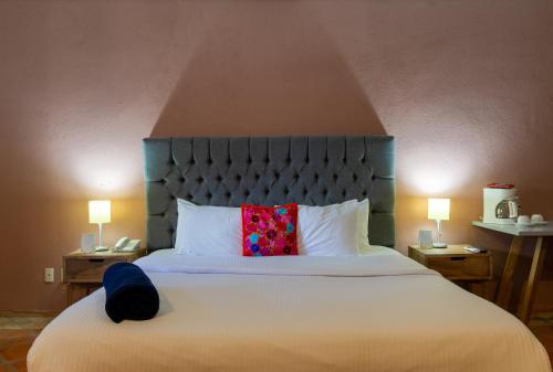 Postel nebo postele na pokoji v ubytování Hotel Hacienda San Cristóbal
