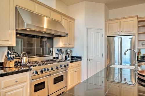 a kitchen with wooden cabinets and a stove top oven at Hot Tub and Mtn Views Peaceful Columbia Retreat! in Columbia