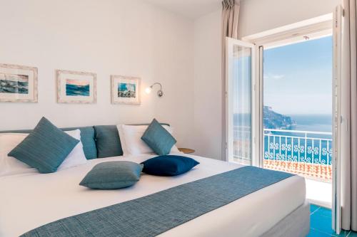 a bedroom with a large bed with a view of the ocean at Casa Dolce Casa in Ravello