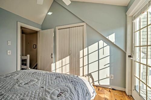 a bedroom with a large bed and large windows at Ocean View and Beach Access Cape Cod Townhome in Mashpee