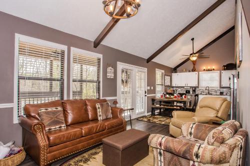 a living room with a couch and chairs and a kitchen at Fox's Den, Hot Tub, FREE Attraction tickets for each paid day, Arcade Game, WIFI!!! in Pigeon Forge