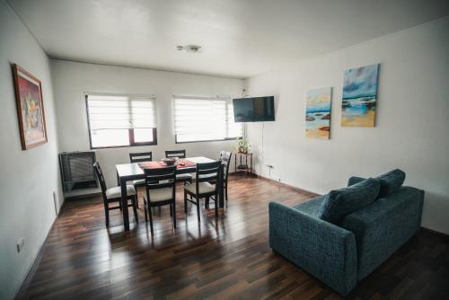 a living room with a table and chairs and a couch at Departamento Ideal in Ushuaia
