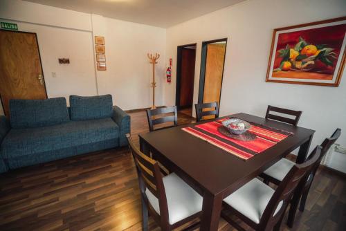 a dining room with a table and a couch at Departamento Ideal in Ushuaia