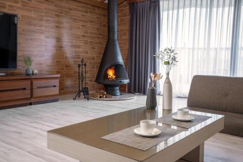 a living room with a fireplace and a table at Home Fourest Resort Geoje in Geoje 