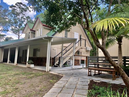 a house with a bench in front of it at Woodford Gardens in Woodford
