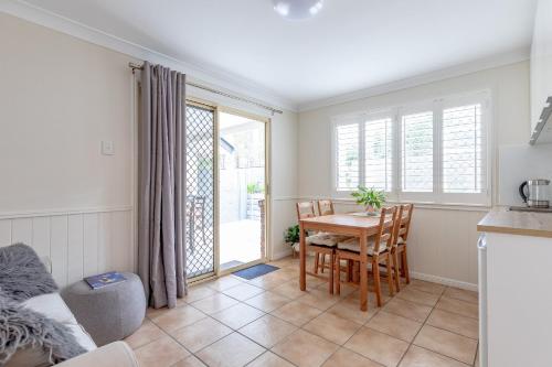 a kitchen and dining room with a table and chairs at Woodford Gardens in Woodford