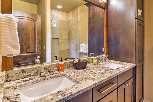 a bathroom with two sinks and a large mirror at Frisco Condo with Rooftop Deck Walk to Main St! in Frisco