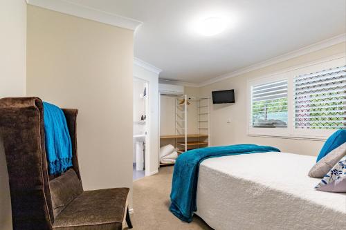 a bedroom with a bed and a window at Woodford Gardens in Woodford