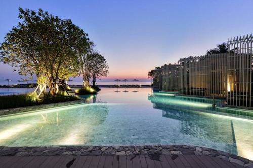a swimming pool at night with the water at Veranda residence pattaya By Kzy in Jomtien Beach