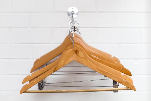 a group of wooden utensils hanging from a rack at Bay Hotel Apartments in Hobart
