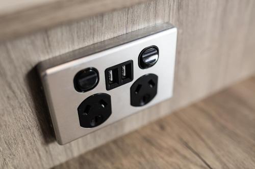 an electrical outlet on the side of a wall at Bay Hotel Apartments in Hobart