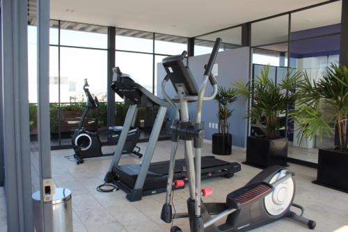 a gym with three tread machines in a building at Small cozy apartment in the historic center in Puebla
