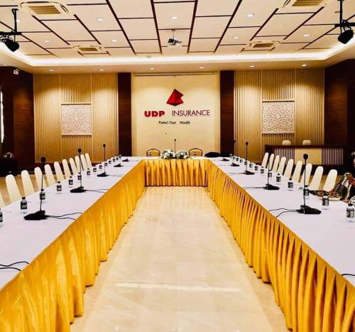 a large conference room with a long table and chairs at Southern Airport Hotel Hatyai in Hat Yai