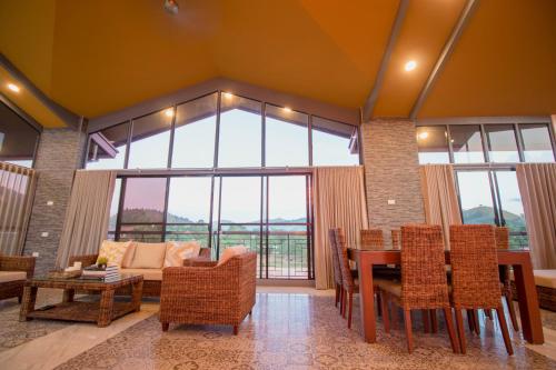 a living room with a table and chairs and a couch at Bella Villa Coron in Coron